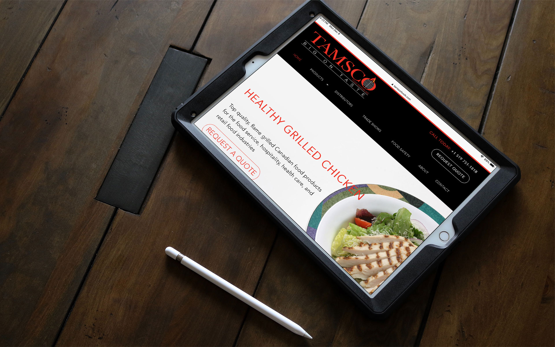 Tamsco Food Systems home page displayed on an iPad on a table.