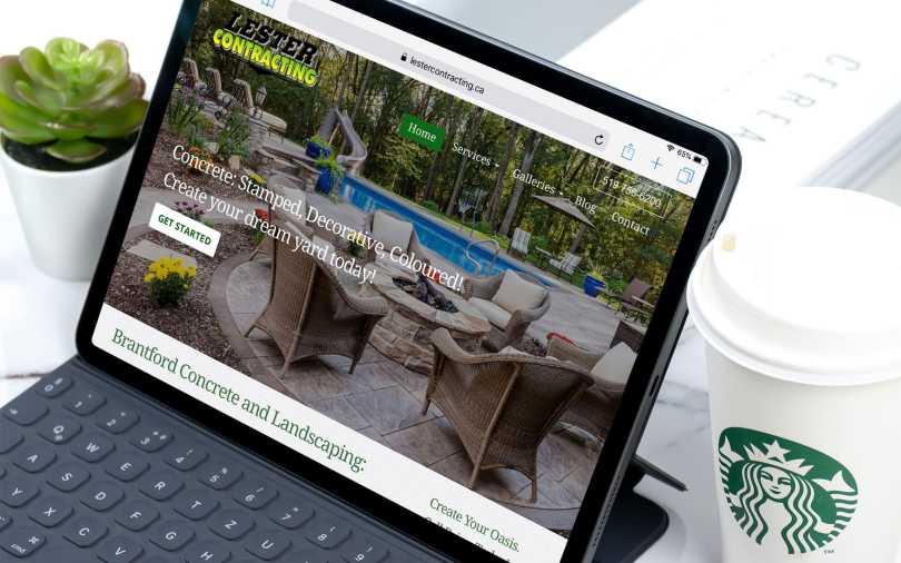 iPad on desk displaying Lester Contracting home page.
