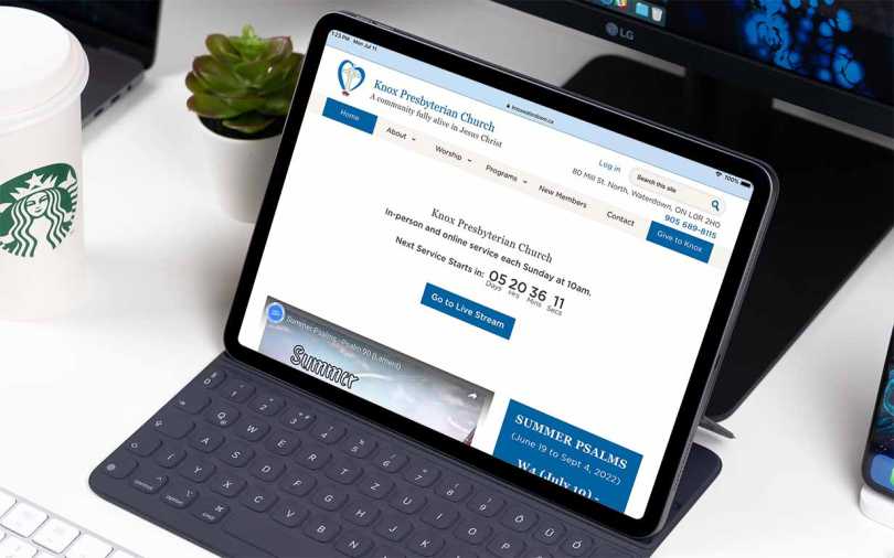 iPad on a table showing home page of the new Knox Waterdown web site.